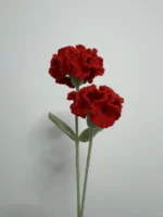 Crocheted red carnations with green leaves.