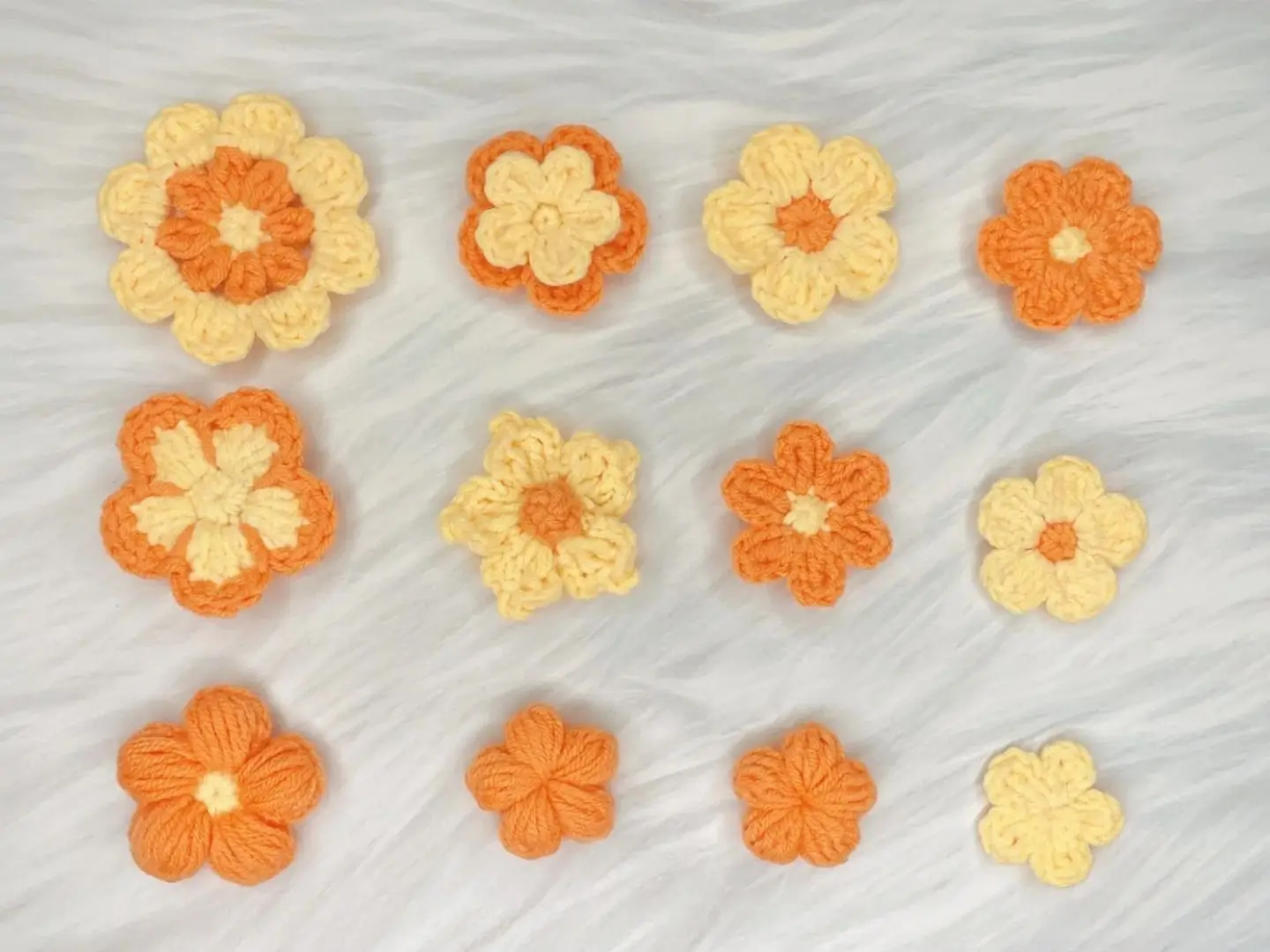 Crochet flowers, orange and yellow,  various sizes.