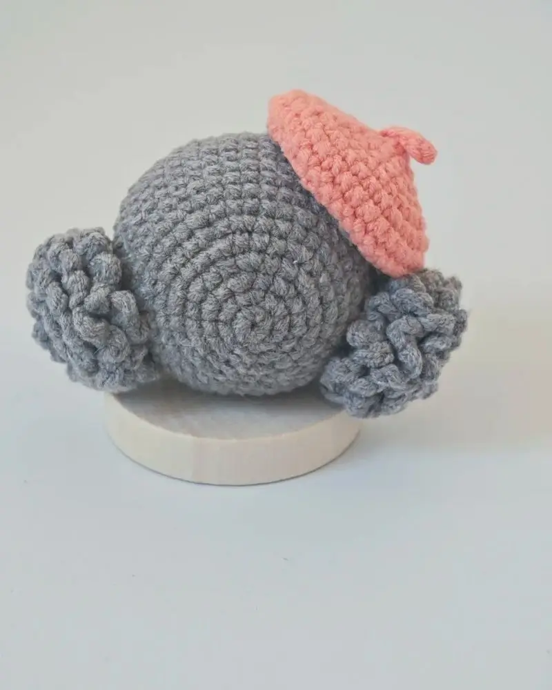 Gray crochet doll with pink beret.