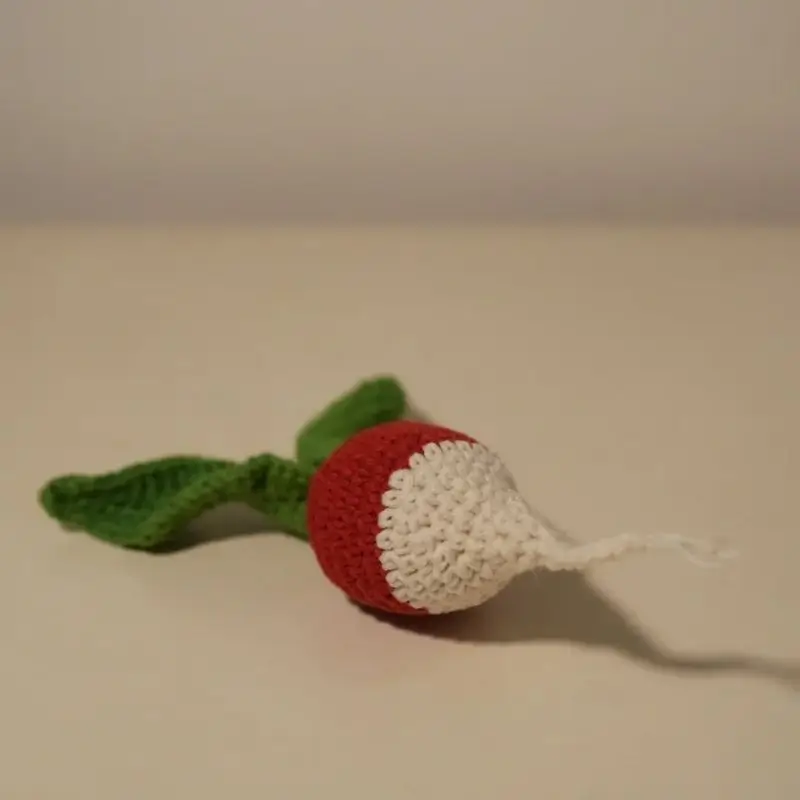Crocheted radish toy, red and white.