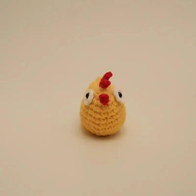 Crocheted yellow chicken toy.