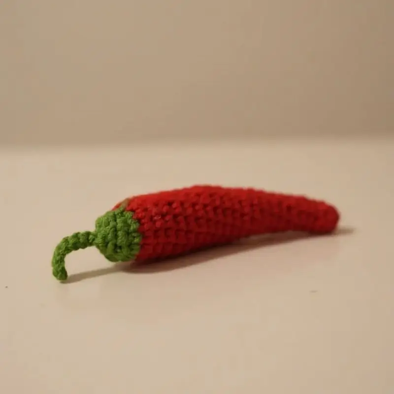 Crocheted red chili pepper toy.