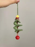 Crocheted Christmas tree ornament, green, spiral design, red bell.