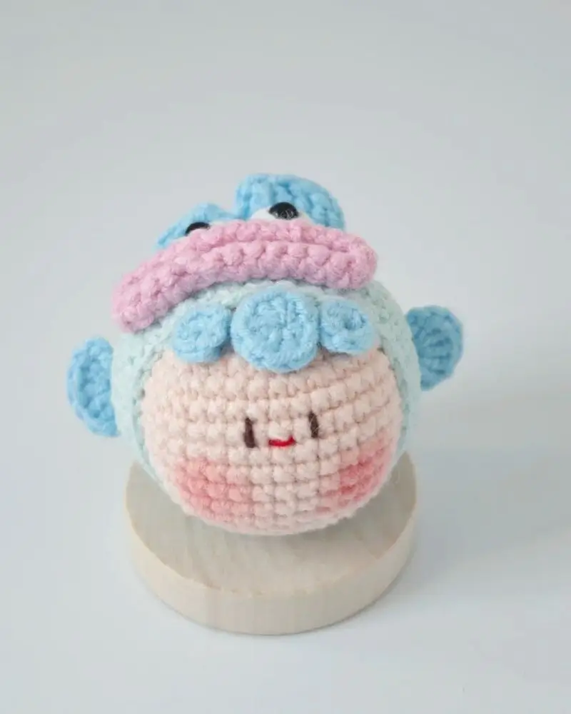 Cute crocheted creature, pastel colors.