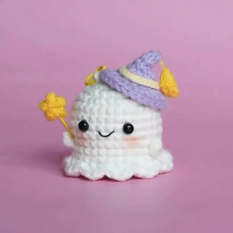 Cute crocheted ghost wearing a purple witch hat.  Spooky Halloween charm.