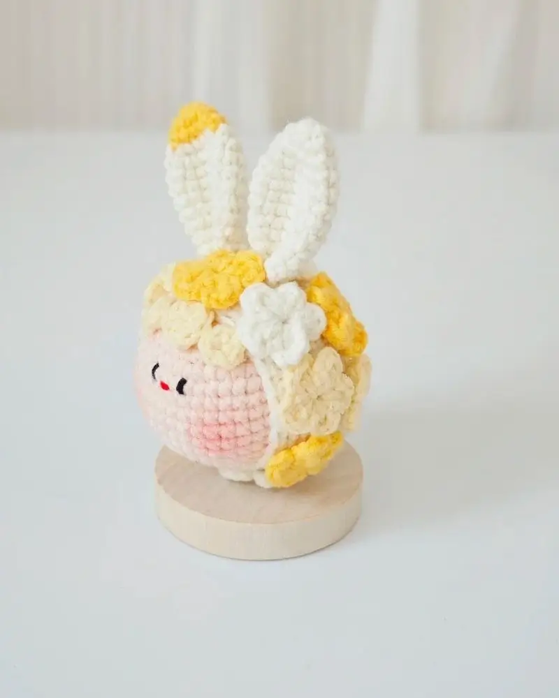 Crocheted bunny, pastel colors, yellow accents.