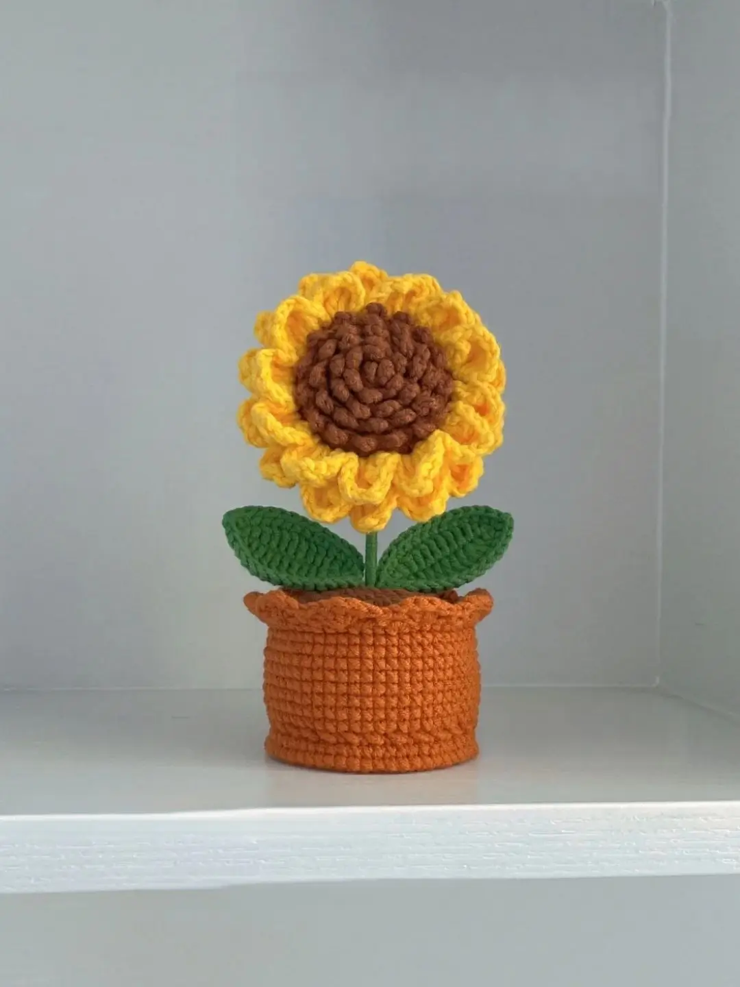 Crocheted sunflower in pot.