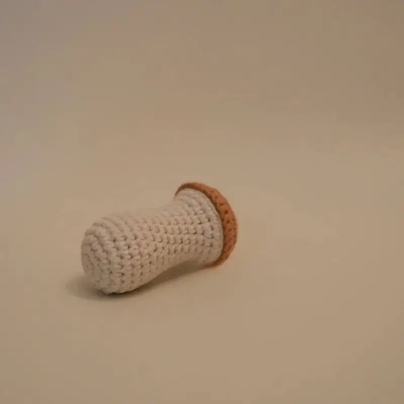 Crocheted baby toy, light beige.