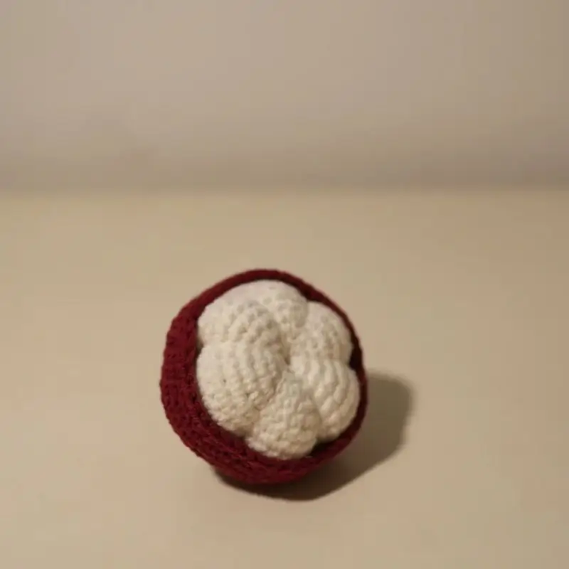 Crocheted mangosteen fruit.