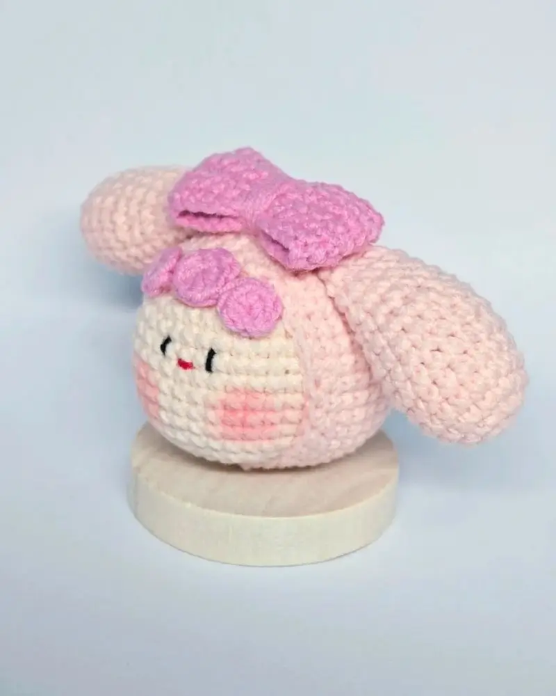 Crocheted pink bunny, kawaii style, bow.