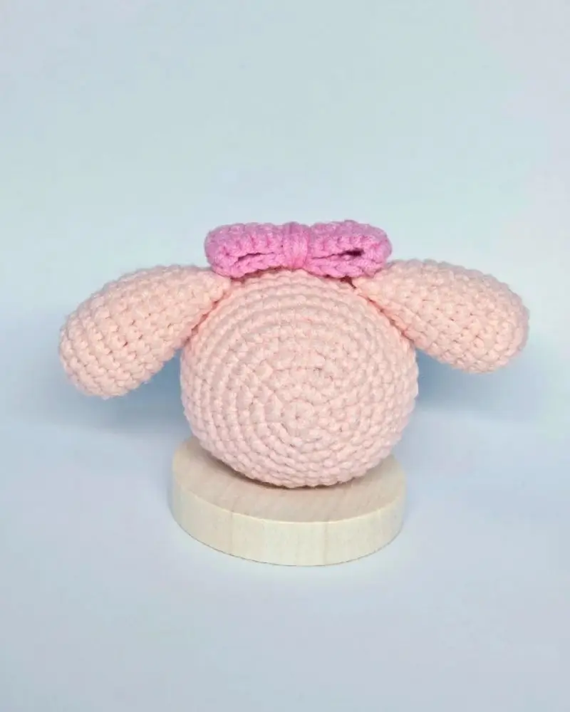 Pink crocheted animal, bow.