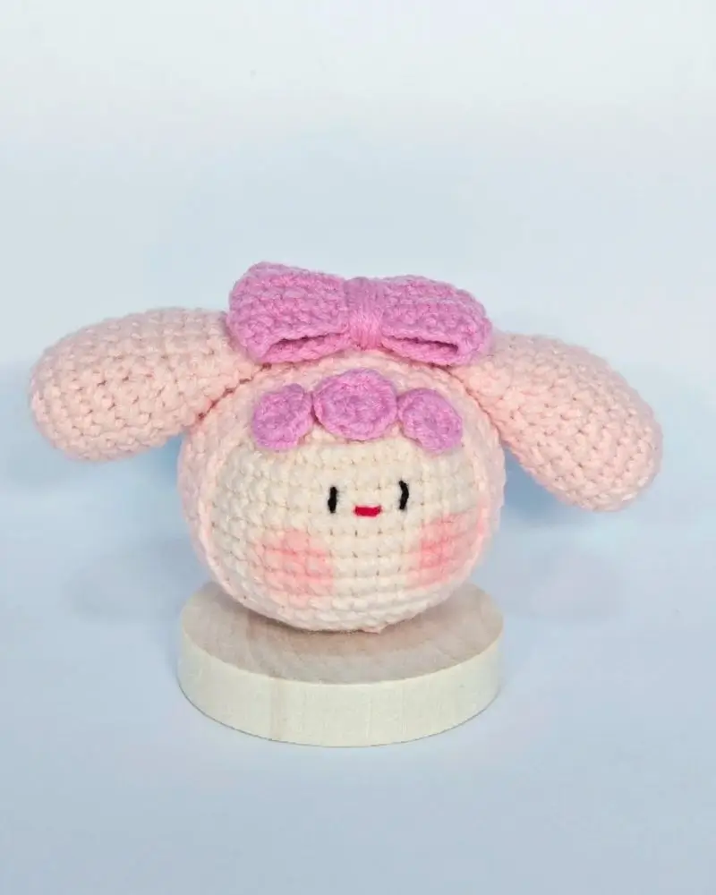 Pink crocheted amigurumi doll, bow,  cute.