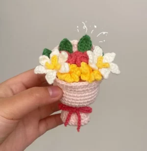 Crochet flower bouquet in a small pink basket.