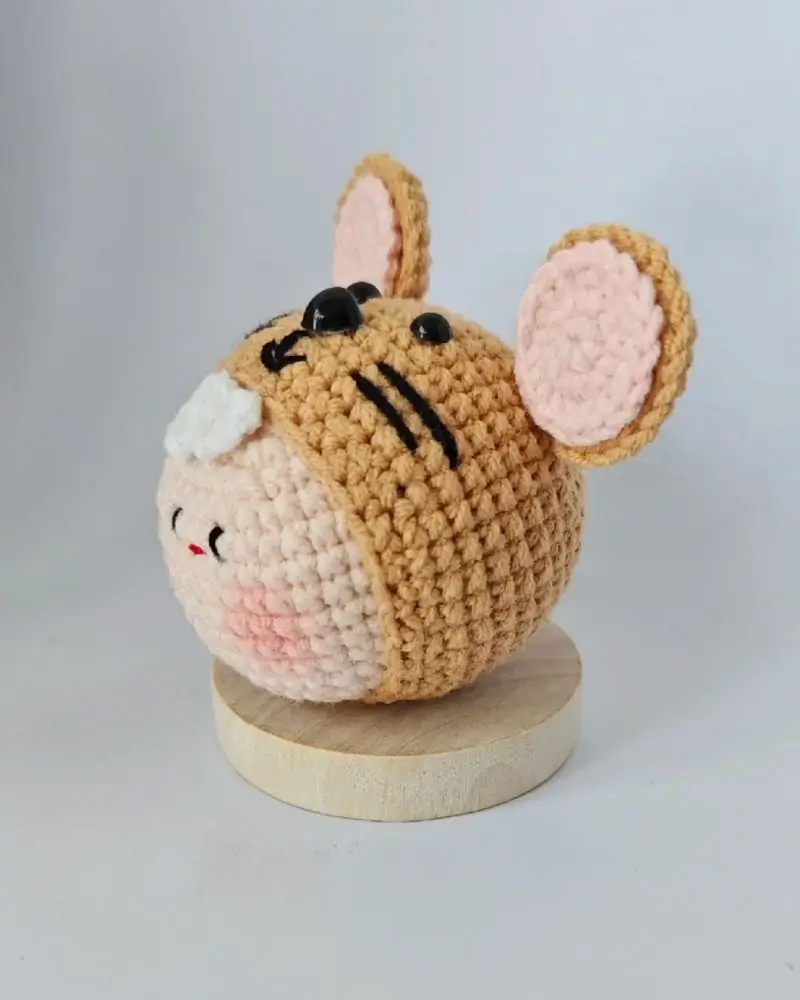 Crocheted tiger-themed stuffed animal.