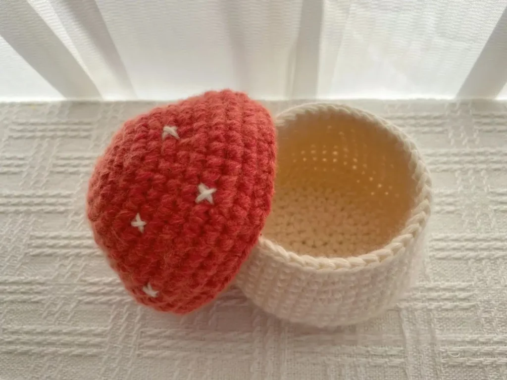Crocheted mushroom, red cap, white stem.