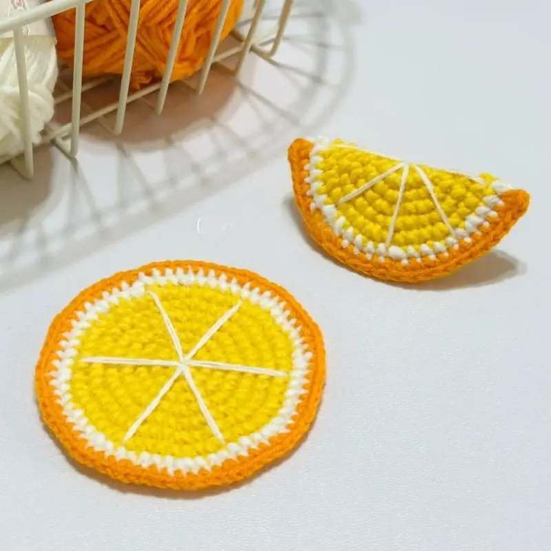 Crocheted orange slices, yellow and orange yarn.
