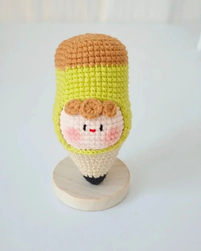 Crocheted pencil figurine,  cute face.