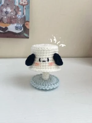Crocheted lamp, cartoon dog, white, light blue base.