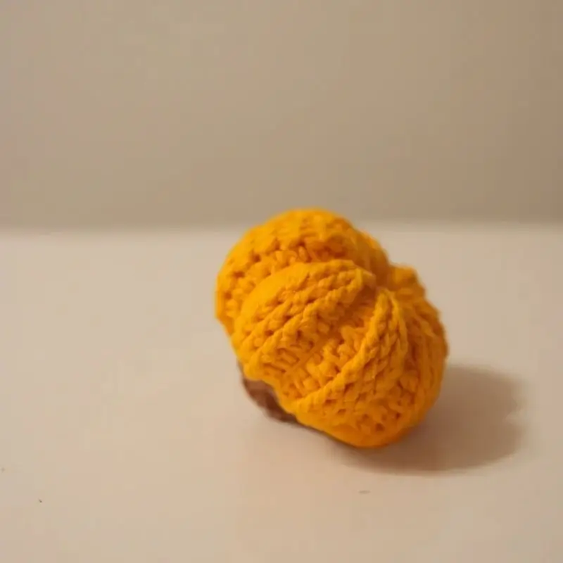 Small, knitted, mustard-yellow beanie.