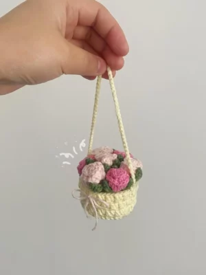 Crocheted flower basket with pink roses.