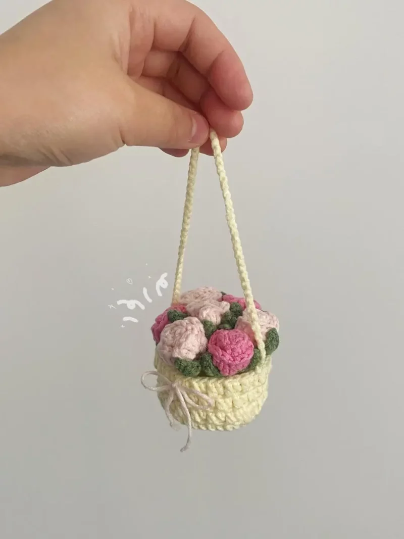 Crocheted flower basket with pink roses.