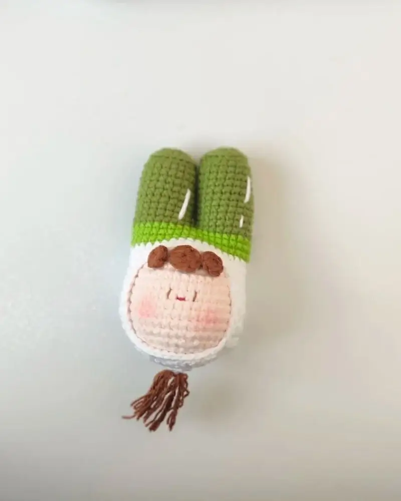 Crocheted bunny toy, green and white.