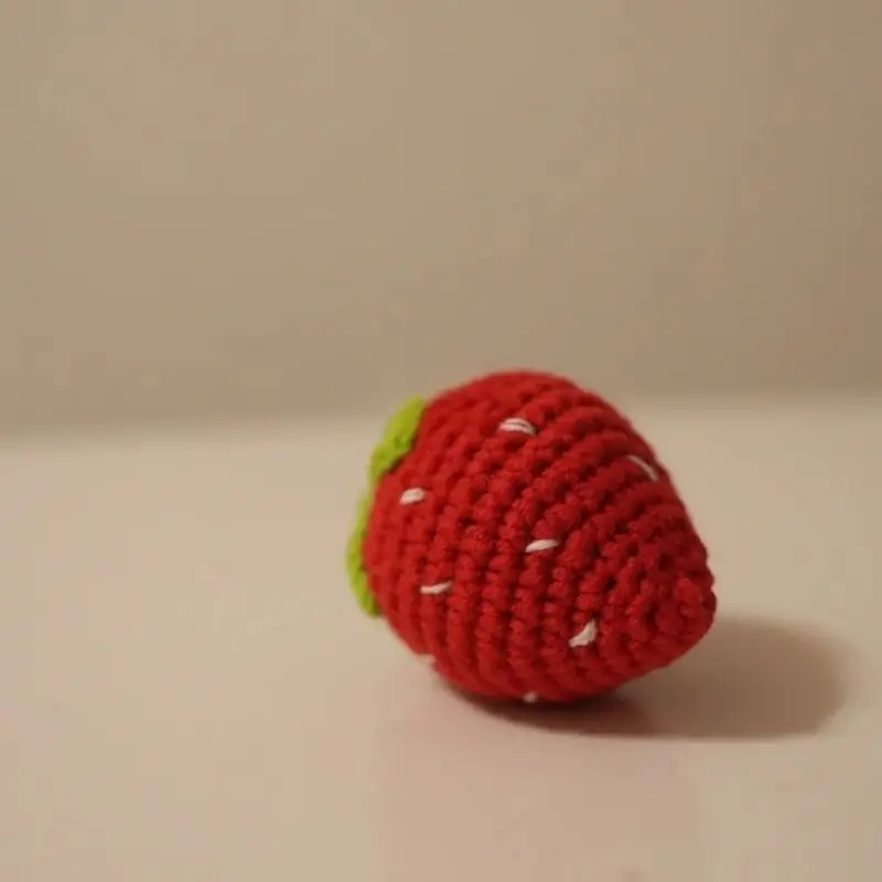 Crocheted strawberry toy.