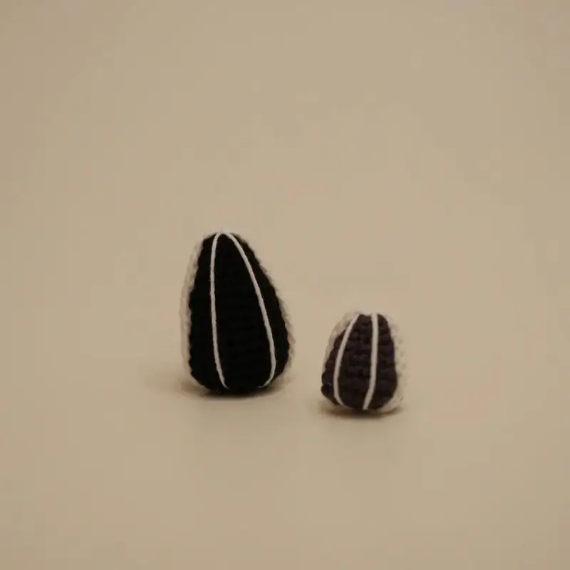 Crocheted sunflower seeds, black and white.
