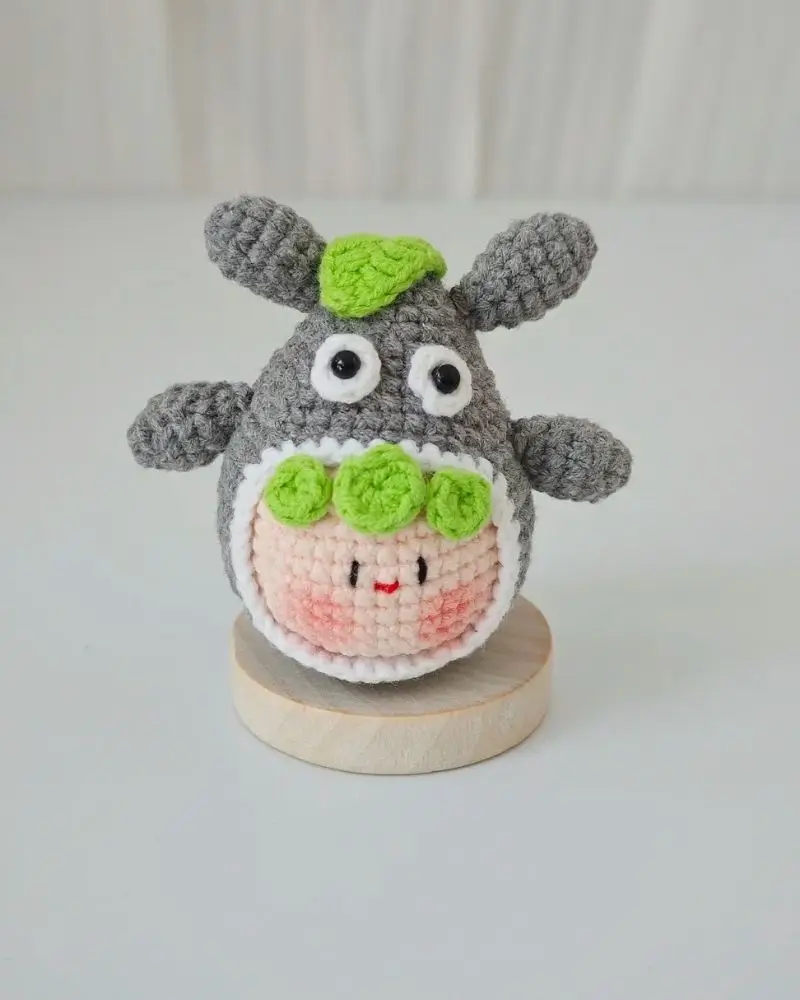 Cute gray amigurumi, green details, crochet.