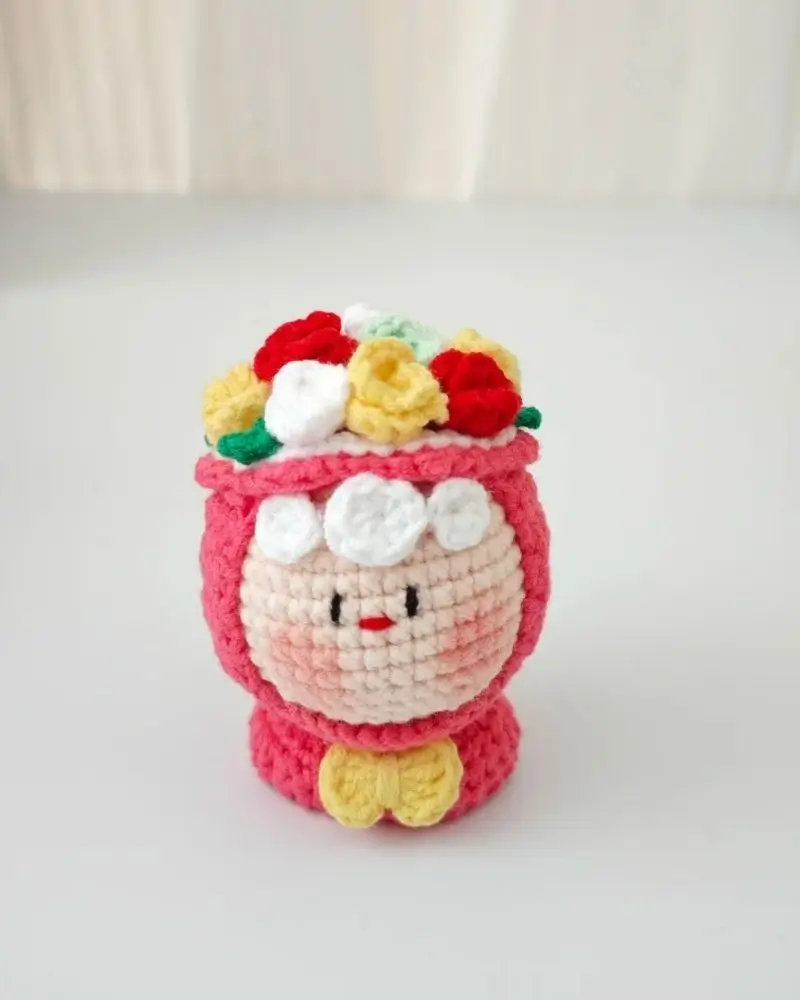 Crocheted doll, flower crown, pink, amigurumi.