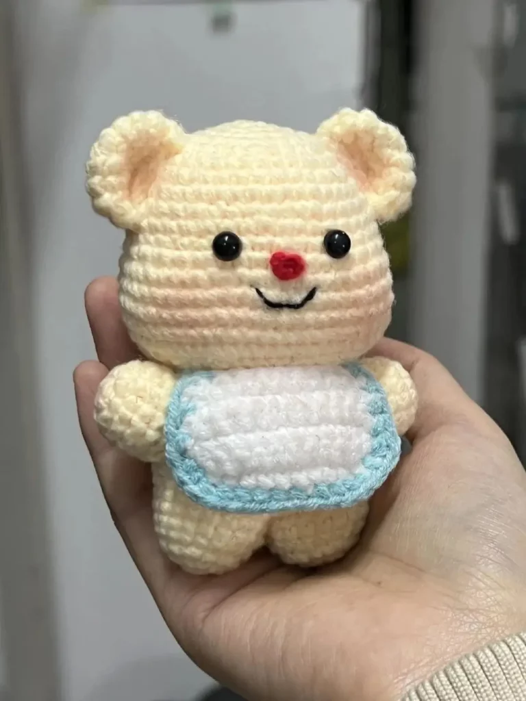 Cute crocheted bear, light yellow, bib.