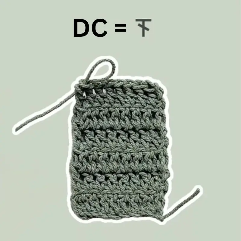 Crochet DC stitch example, gray textured fabric.