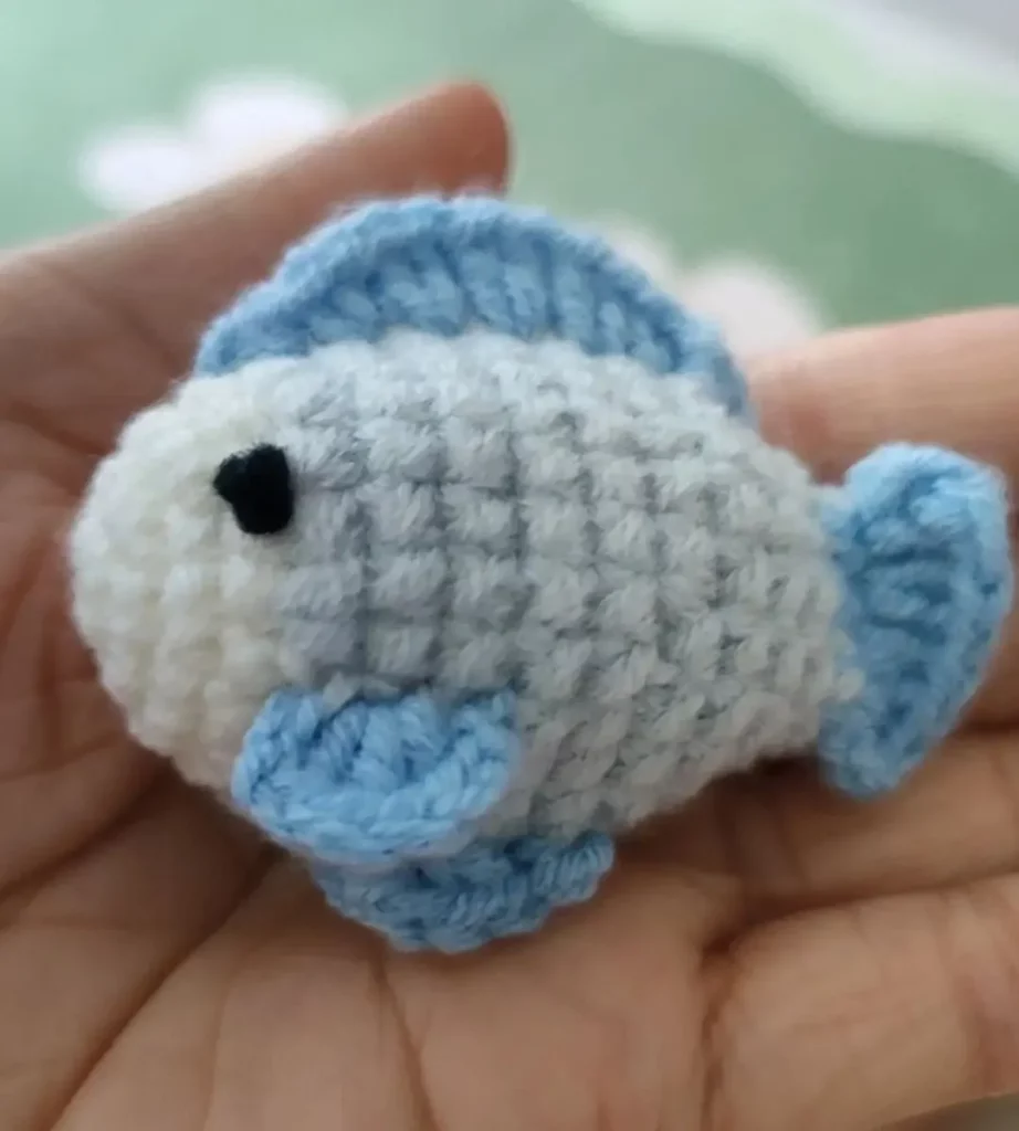 Crocheted fish, light gray and light blue.