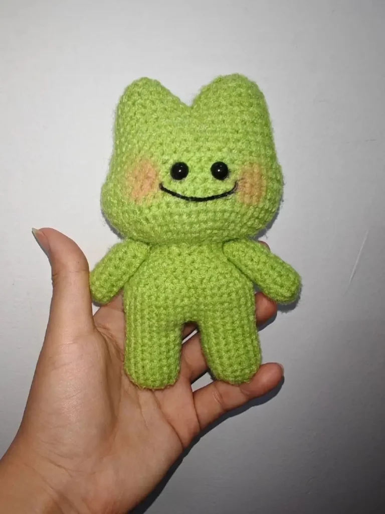 Crocheted lime green frog toy.