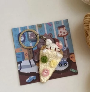 Crochet pizza slice keychain.