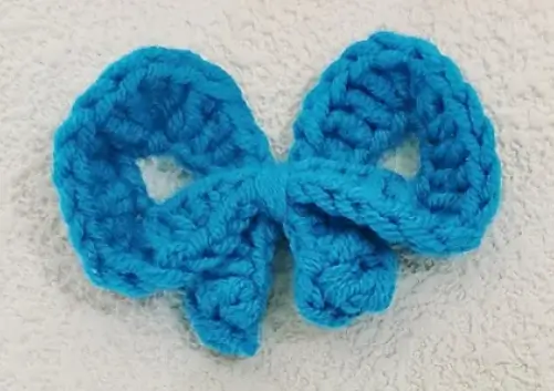 Bright teal crocheted bow.