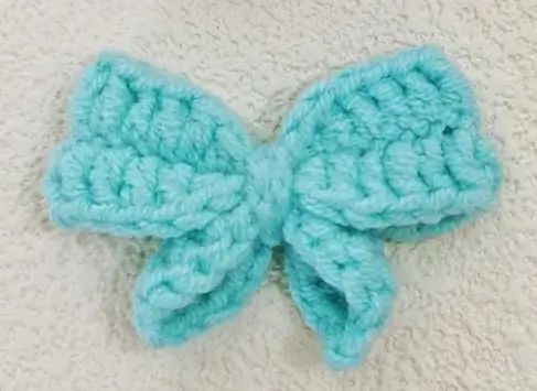 Light teal crocheted bow.