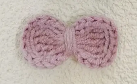 Pink crocheted bow.