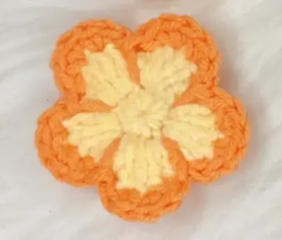 Crocheted orange flower, two-tone.