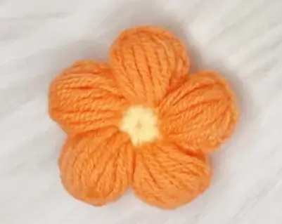 Orange yarn crocheted flower.