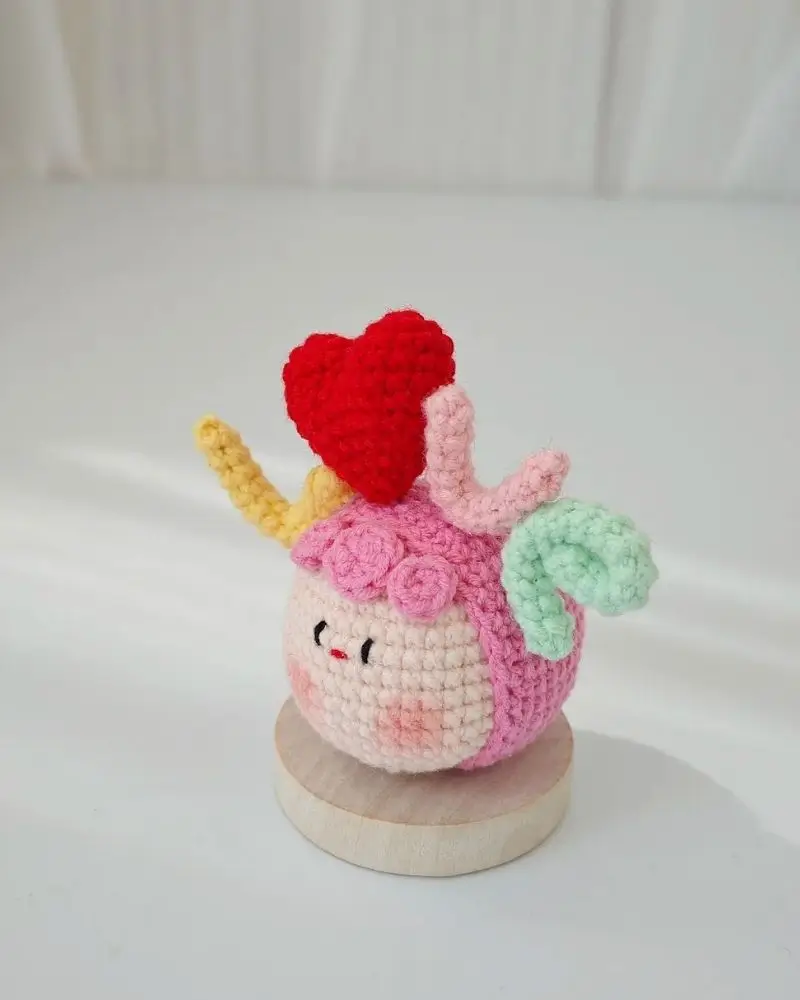 Handmade crochet unicorn, heart, pastel colors.