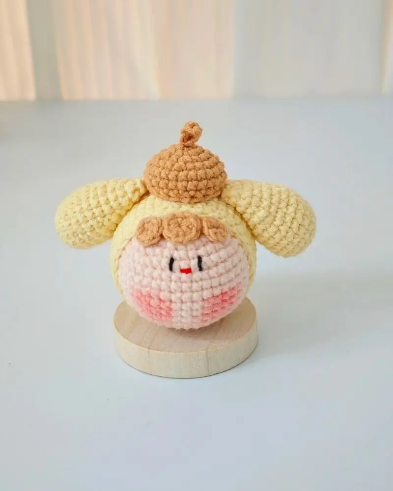 Cute crocheted doll, pastel yellow and peach.