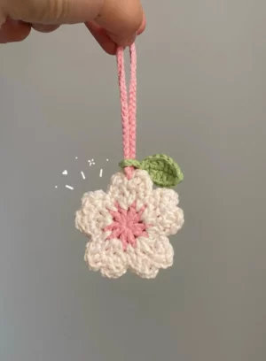 Crochet cherry blossom charm, pink and cream.