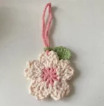 Crocheted cherry blossom charm, pink and cream.