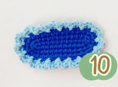 Crocheted oval, blue with light blue edge, step 10.