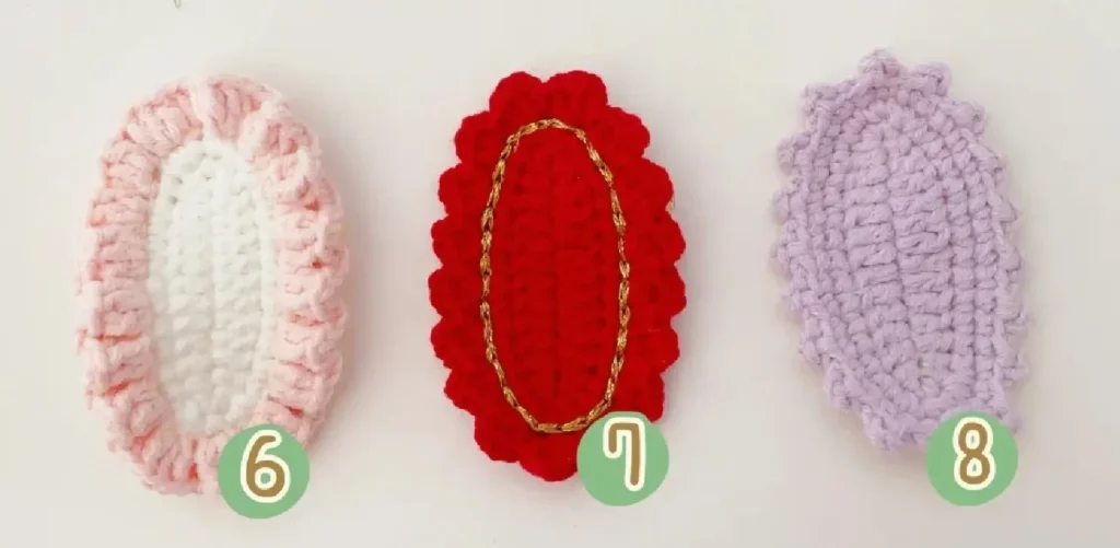 Crochet oval shapes, numbered 6, 7, and 8.  Pink, red, and lavender.
