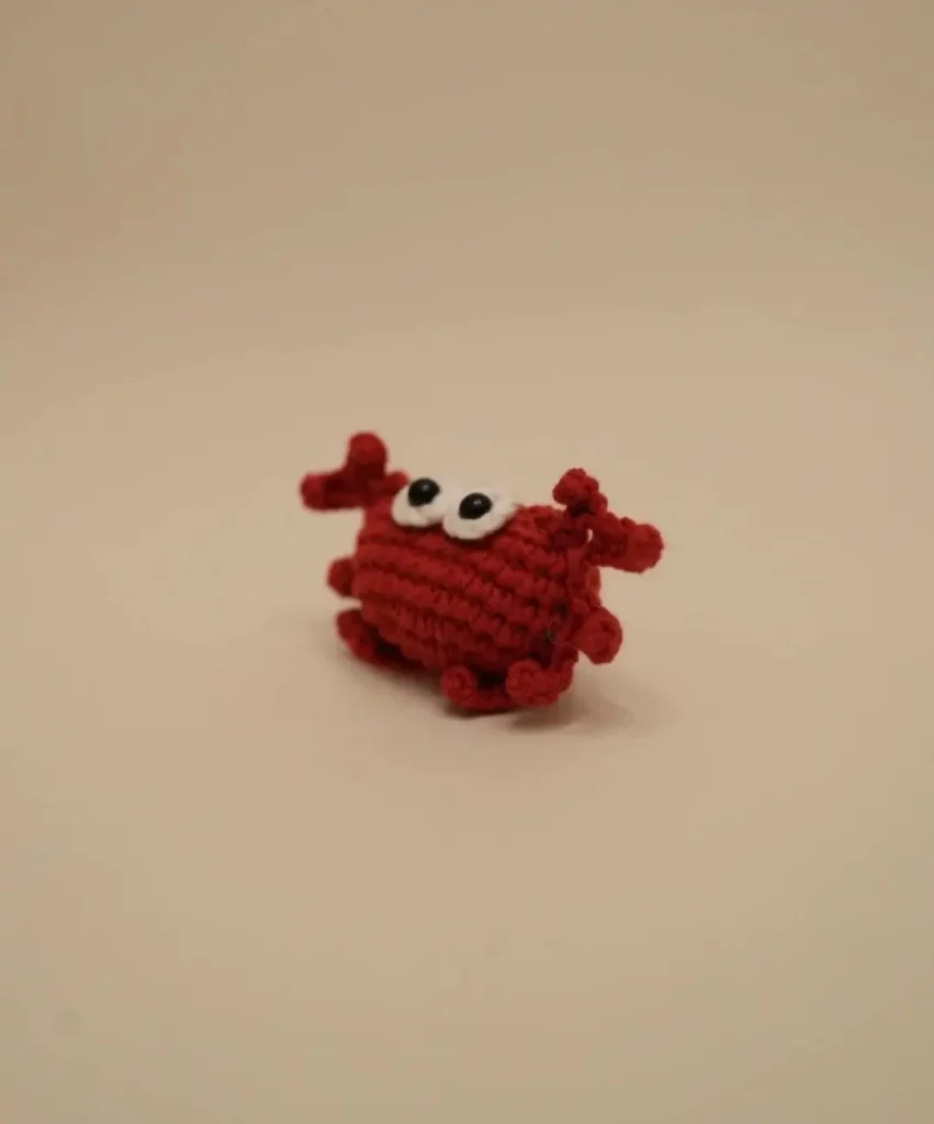Crocheted red crab toy.