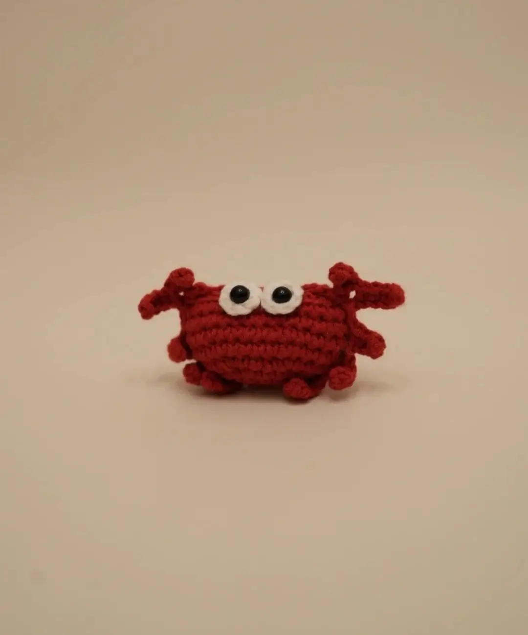 Crocheted red crab toy.