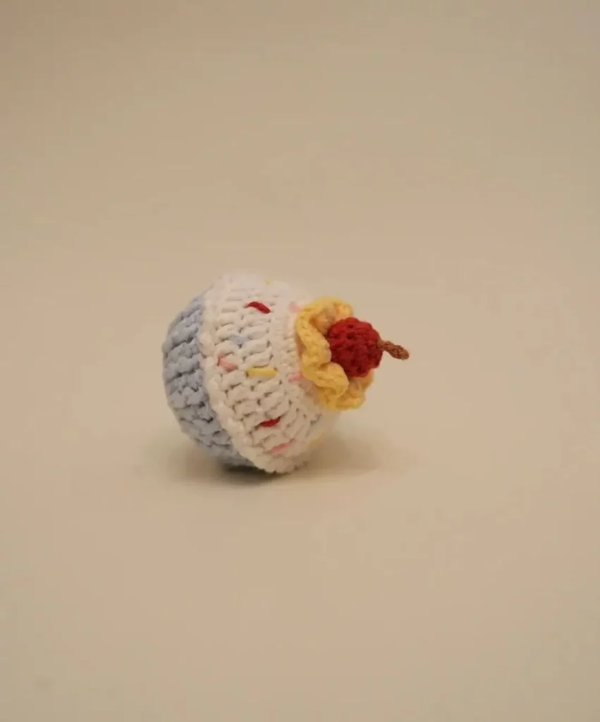 Crochet cupcake toy, light blue and white.
