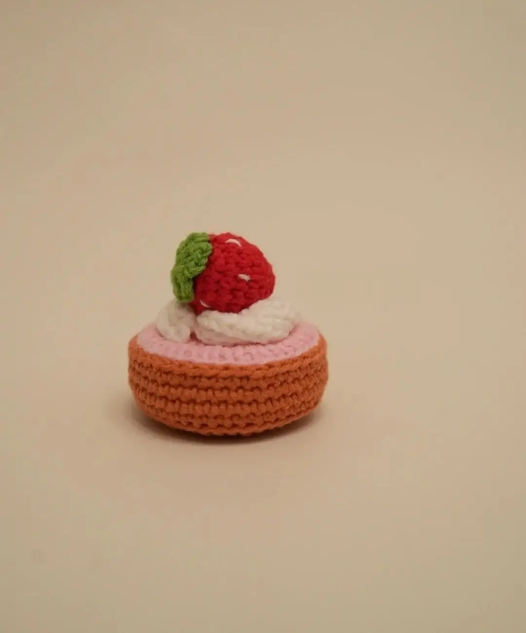 Crocheted strawberry cake,  pink and orange.